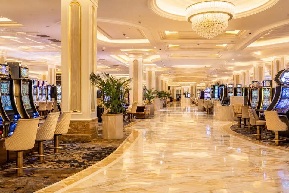 Bright gaming floor with machines and polished aisles at Ontario Gaming Club